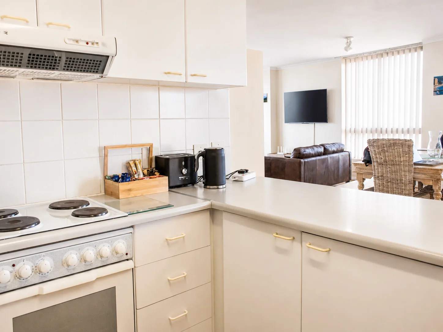 Equipped self-catering kitchen with breakfast counter opening onto the apartment living and dining area